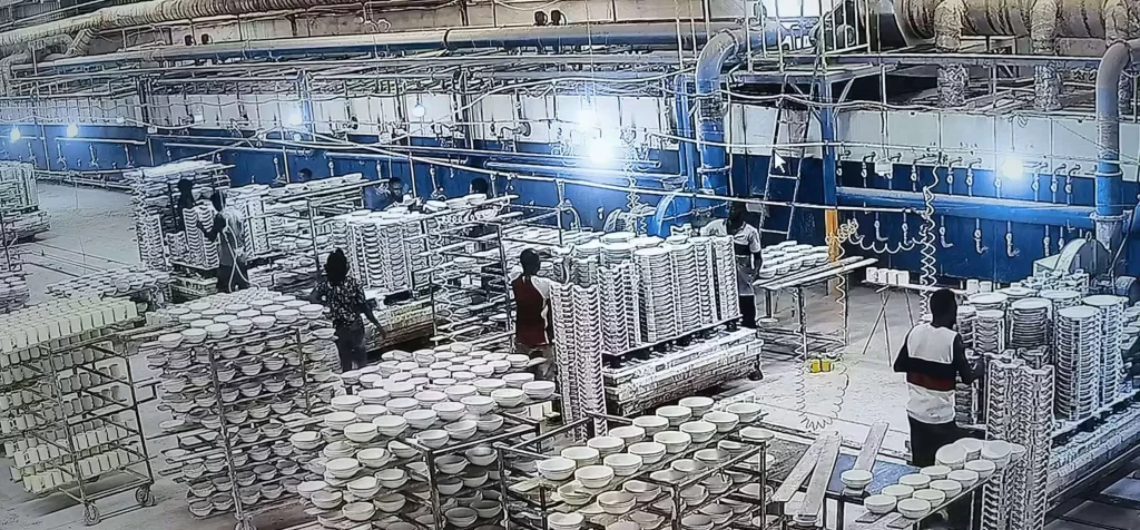 Rows of ceramic ware, production equipment and kiln-floor workstations