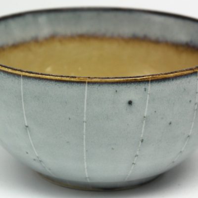 Grey reactive glaze bowl with vertical line decoration and ochre interior