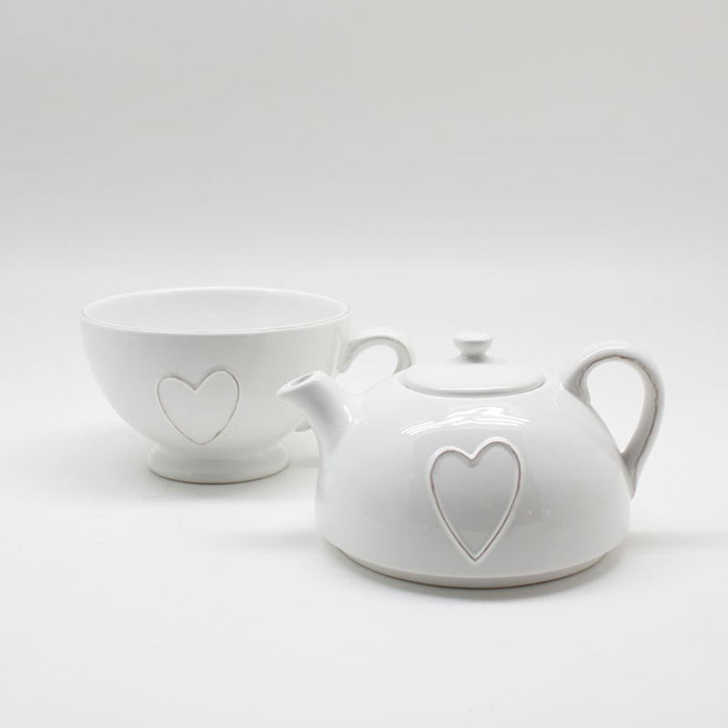 White teapot and cup with raised heart motifs