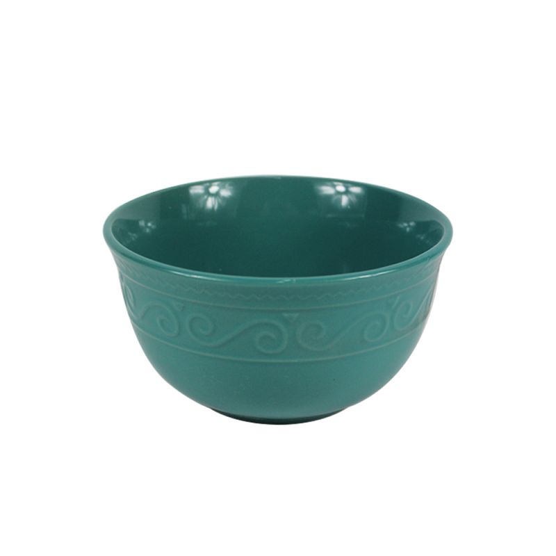 Teal bowl with raised scroll patterns around its outer wall